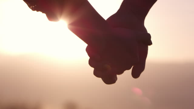 Hand holding, sunset